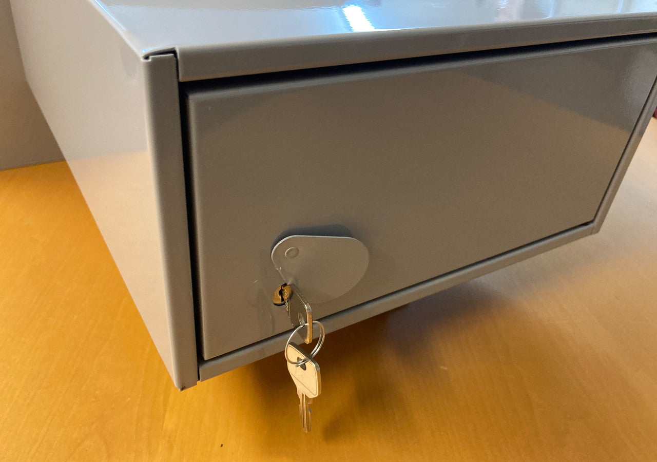 Rear view fire rated mail drop slot showing key